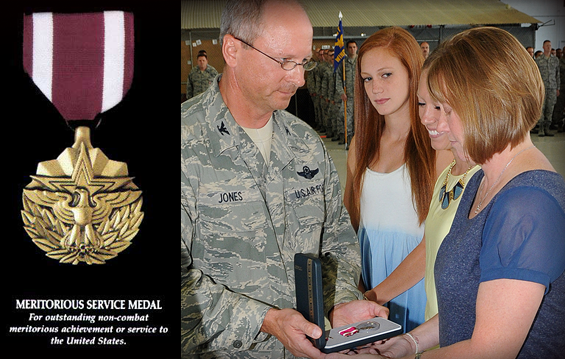 Col. James Jones (left), 121st Air Refueling Wing commander, presents the Meritorious Service Medal to the Family of Senior Master Sgt. Tim Caudill.