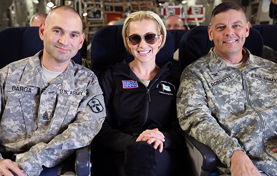 Command Sgt. Maj. Scott Barga (left) and Col. Gregory Robinette (right), leadership team for the 371st Sustainment Brigade, sit with country music artist Kellie Pickler.