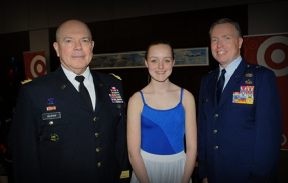 Lt. Gen. William E. Ingram Jr. (left), Army National Guard director, and Brig. Gen. Bruce Prunk (right), Oregon assistant general for Air, pose for a photo with Molly Frey, daughter of Senior Master Sgts. Kim and Renee Frey of the 121st Air Refueling Wing