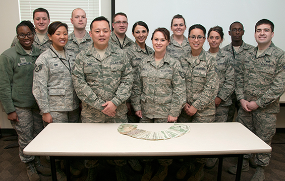 The 178th Fighter Wing Airman/Noncommissioned Officer Council poses with the money collected through a Lucky Penny Drive 