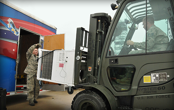 Members of the Joint Incident Sight Communications Capability Team, unload a generator 