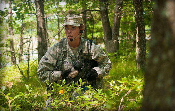 Airman 1st Class Heidi Riffle, a member of the 121st Air Refueling Wing Security Forces Squadron, maneuvers through the woods 
