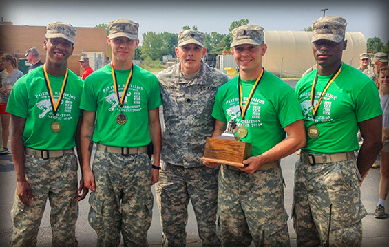 Lt. Col. Perry M. Carper (center), commander of 1st Battalion, 145th Armored Regiment, stands with Pvt. Joseph A. Dokes (from left), Spc. Warren T. Conover, 1st Lt. Michael R. Crow and Sgt. Rashun Lawrence, members of the winning team at the 2014 Minuteman Ironman competition.