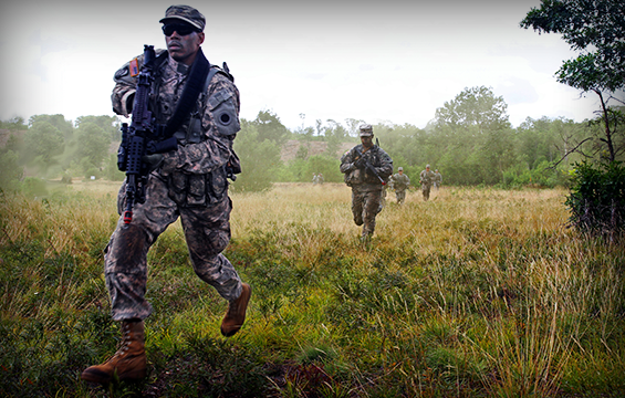 Soldiers of 1st Battalion, 148th Infantry Regiment assault across an objective during a call-for-fire exercise .