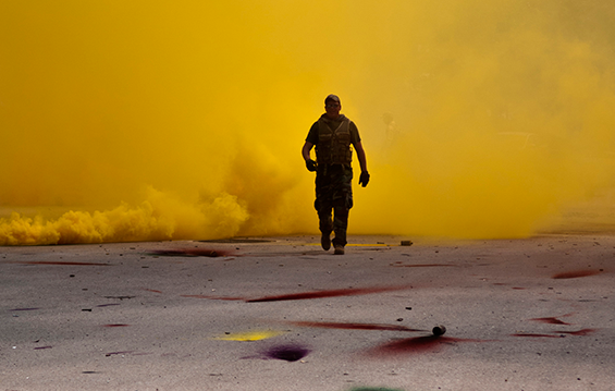 Tech. Sgt. Patrick Linder, a member of the 121st Air Refueling Wing Security Forces Squadron, walks through a cloud of smoke 