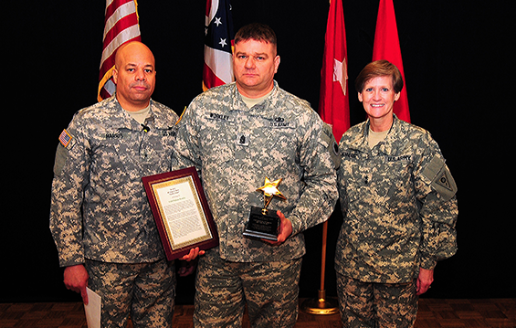 Command Sgt. Maj. William Workley (center), a federal technician with the Ohio Army National Guard's G4 directorate and a Canal Winchester, Ohio, native, receives the Brig. Gen. Roger E. Rowe Quality Award 