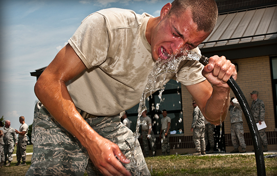 Airman 1st Class Joseph Nenadich, 121st Air Refueling Wing Security Forces Squadron, flushes his face with water after being sprayed with pepper spray.