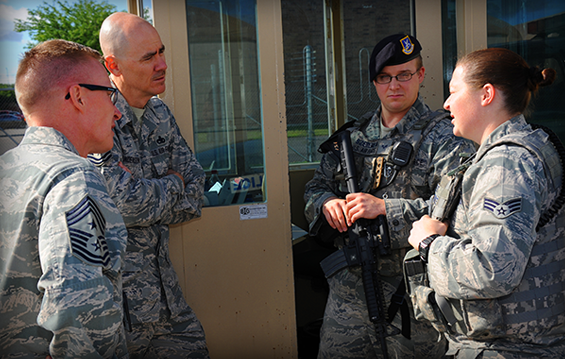 Chief Master Sgt. Ron Anderson (second from left), command chief master sergeant of the Continental U.S. North American Aerospace Defense Command (NORAD) Region-1st Air Force (Air Forces Northern), and Chief Master Sgt. Tracy Troxel (left), 180th Fighter Wing command chief, talk with 180th Security Forces members Senior Airman Bradley Szeremeta (third from left) and Senior Airman Tara Zuber.