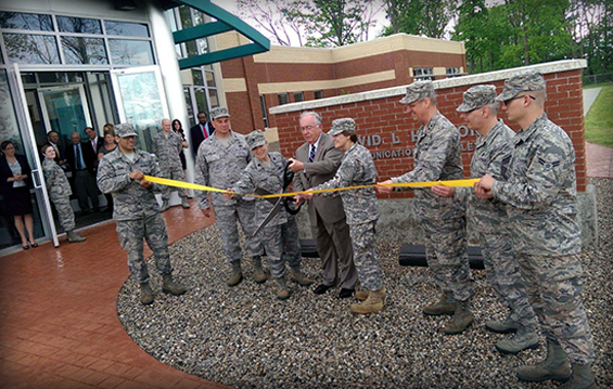Former U.S. Rep. David L. Hobson (fourth from left) and Maj. Gen. Deborah A. Ashenhurst, Ohio adjutant general, conduct the ceremonial ribbon-cutting to open the new Hobson Cyberspace Communications Complex on May 21, 2014, in Springfield, Ohio. 