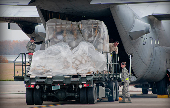 Airmen with the 179th Airlift Wing remove three pallets from a C-130H Hercules and onto a 25K Aircraft Cargo Loader.