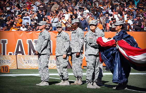 Ohio National Guard Soldiers prepare to take the field with an oversized U.S. flag during pregame ceremonies for the Cleveland Browns' game.