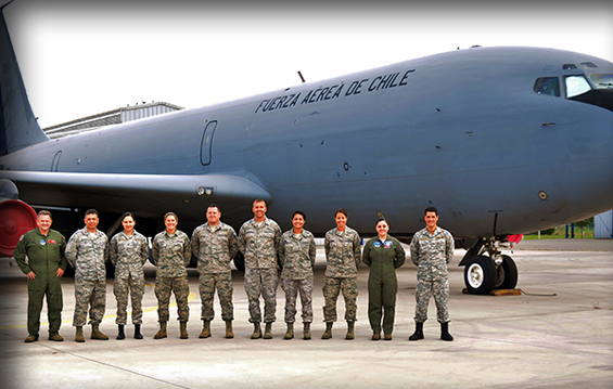 Airmen from the 121st Air Refueling Wing stand with members of the Chilean Air Force in front of a Chilean KC-135E Stratotanker.
