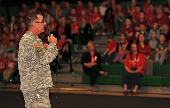 Sgt. 1st Class James Phipps speaks to grades K-12 students at a school assembly during Red Ribbon Week