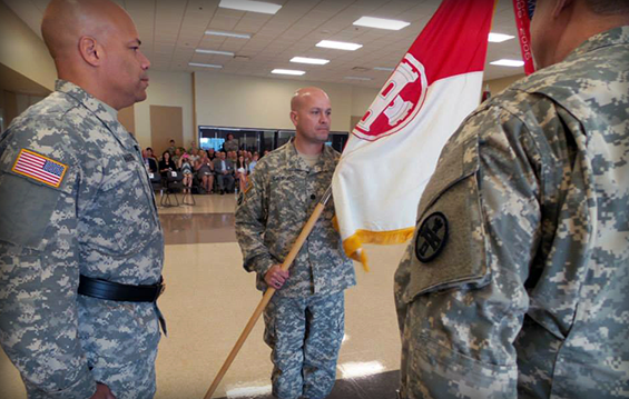 Lt. Col. Ben Capriato (center), incoming commander of 16th Engineer Brigade, holds the brigade's distinguishing flag presented to him by Brig. Gen. John C. Harris Jr. (left), Ohio assistant adjutant general for Army.