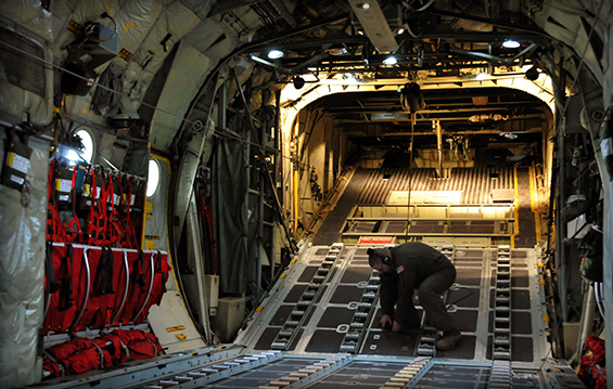 Tech. Sgt. Bryan Thompson, a C-130H Hercules loadmaster, prepares the inside.