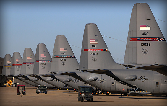 Seven C-130H Hercules sit on the flight line at the 179th Airlift Wing in Mansfield, Ohio.
