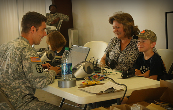 Staff Sgt. Josh Adams, a patient administration specialist with the Ohio Army National Guard Medical Detachment, registers local community members for health screenings.