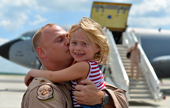 Maj. Matt Boyle, a KC-135 Stratotanker pilot with the 121st Air Refueling Wing, embraces his daughter upon arrival Aug. 11, 2015, at Rickenbacker Air National Guard Base in Columbus, Ohio. Boyle and other unit members had been deployed to Al Udeid Air Base, Qatar.