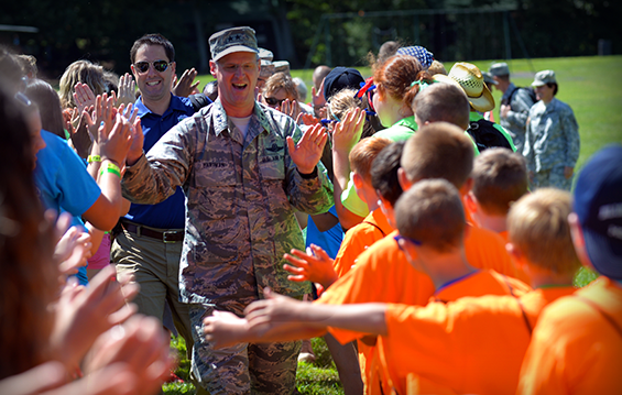 Maj. Gen. Mark E. Bartman, Ohio adjutant general, heads a group of Ohio National Guard leaders and elected officials who are greeted upon their arrival to Operation Military Kids Camp Kelleys Island.