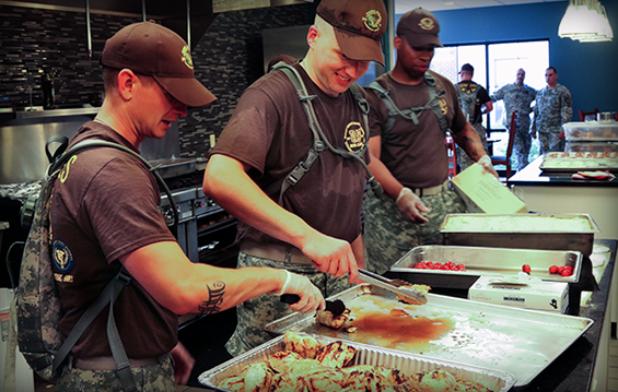 Members of Ohio Army National Guard Warrant Officer Candidate School Class 15-001 prepare a meal for Families staying at the Ronald McDonald House.