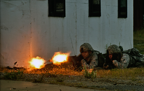 Airman 1st Class Brice Edstrom and Senior Airman Jacob Boseker, members of the 121st Security Forces Squadron, provide suppressive fire with an M240B machine gun.