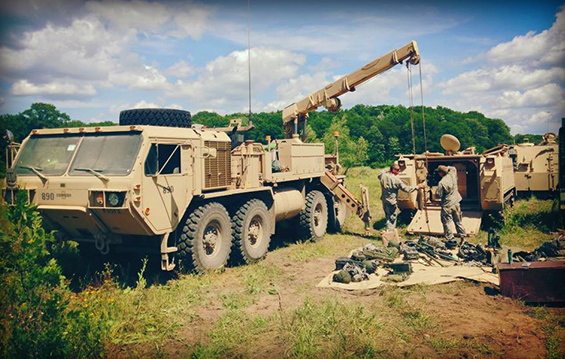 Mechanics from the 737th Support Company (Forward) repair and prepare an M1064 tracked mortar carrier.
