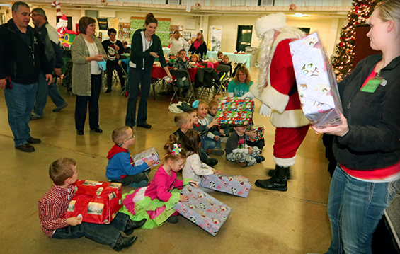 Santa Claus hands out presents to children attending the Maj. Gen. Robert S. Beightler Armory Children's Christmas Party.