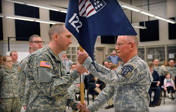 First Sgt. Ryan Scarberry (left) hands the 122nd Army Band guidon to Chief Warrant Officer 4 Robin D. Kessler .