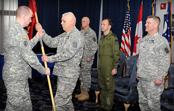 Task Force Luzon Command Sgt. Major Bob Keiser (second from left) receives the guidon from Staff Sgt. Christopher Wagstaff