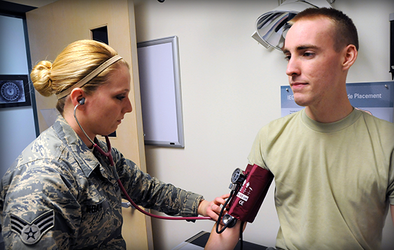 Senior Airman Caitlin Noah (left), a 178th Wing health systems technician, checks the blood pressure of Senior Airman Brian McGinnis.