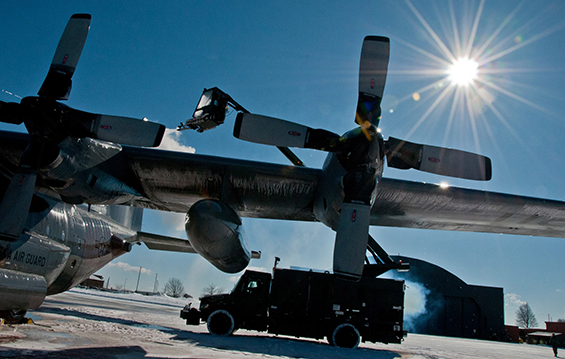 Airmen with the 179th Airlift Wing battle the cold weather and work to de-ice a C130H Hercules aircraft.
