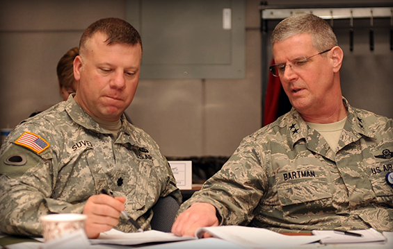 Maj. Gen. Mark E. Bartman (right), interim Ohio adjutant general, talks with Lt. Col. Jeffrey A. Suver, deputy director of joint operations (J3) for the Ohio National Guard, during a tabletop exercise.