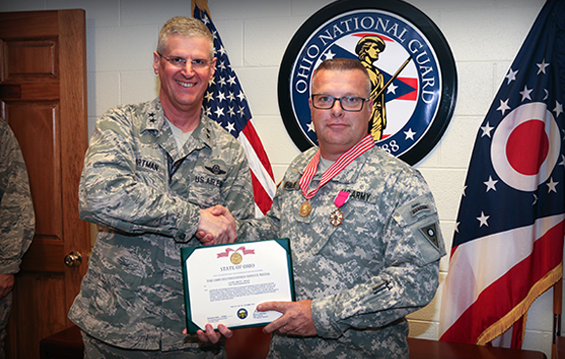 Maj. Gen. Mark E. Bartman (left), Ohio adjutant general, presents the Ohio Distinguished Service Medal to Col. Timothy Whalen.