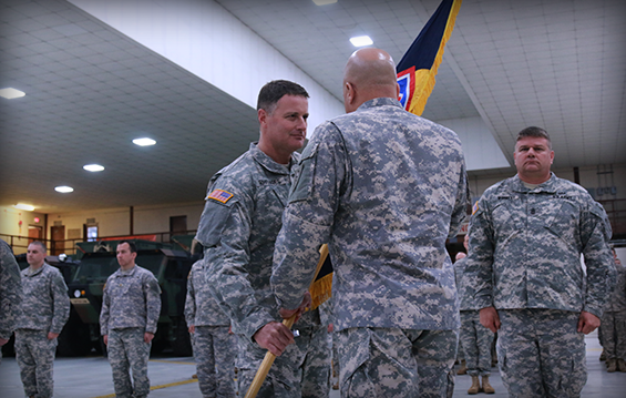 Col. Stephen L. Rhoades (left), the incoming commander of the 73rd Troop Command, accepts the brigade colors from Maj. Gen. John C. Harris Jr., Ohio assistant adjutant general for Army