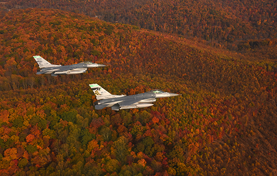 Amid a colorful fall background, F-16 Fighting Falcons from the 180th Fighter Wing conduct a routine training mission.