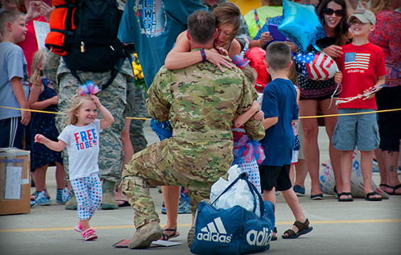 An Airman with the 179th Airlift Wing is greeted by Family members following his return from an overseas deployment.