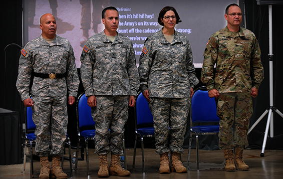 Maj. Gen. John C. Harris Jr. (from left), Ohio assistant adjutant general for Army, Col. Anthony P. Digiacomo II, incoming commander, Special Troops Command (Provisional), Brig. Gen. Maria E. Kelly, outgoing commander, STC, and Chaplain (Col.) Daniel Burris sing “The Army Song” at the conclusion of a change of command ceremony.