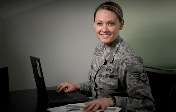 Staff Sgt. Jennifer D. Masters, an Airman with the 178th Wing, poses for a photo at her desk.