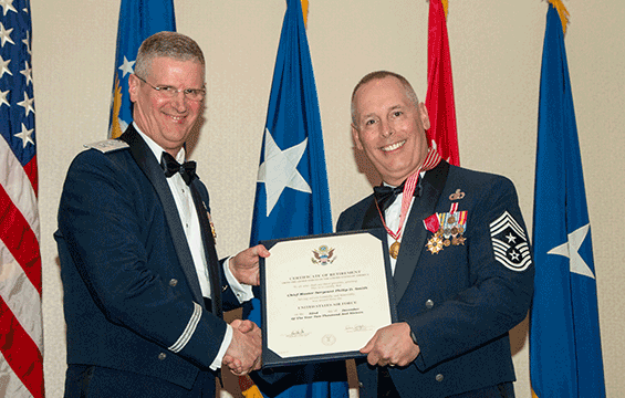 Maj. Gen. Mark E. Bartman (left), Ohio adjutant general, presents the Ohio Distinguished Service Medal to Chief Master Sgt. Philip D. Smith, state command chief for Air, during Smith’s retirement ceremony.