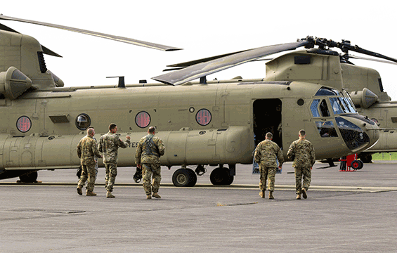 Soldiers head toward two CH-47 Chinook helicopters to transport personnel, equipment and supplies in support of Hurricane Harvey relief efforts. 