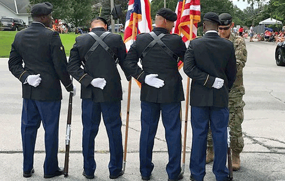A color guard from the 1486th Transportation Company composed of Spc. Lance Franklin (from left), Sgt. Miguel Siano, Master Sgt. Timothy Bellville and Pfc. Wesley Wilkins are inspected by company 1st Sgt. James Crawford before marching in a parade.