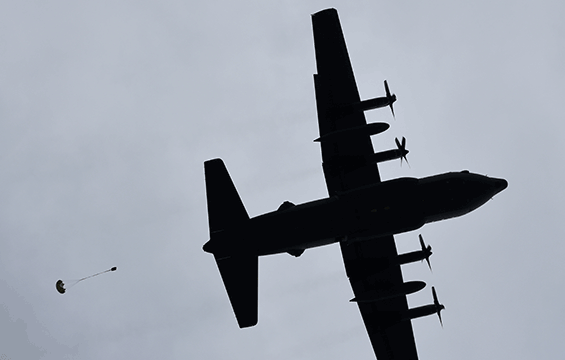 A C-130H Hercules air dropping supplies.
