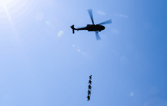 Soldiers with 2nd Squadron, 107th Cavalry Regiment, are hoisted more than 300 feet into the air underneath a UH-60 Black Hawk helicopter.
