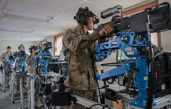Soldiers with the 1485th Transportation Company operate simulated M2 .50-caliber machine guns at the Virtual Convoy Operations Trainer.