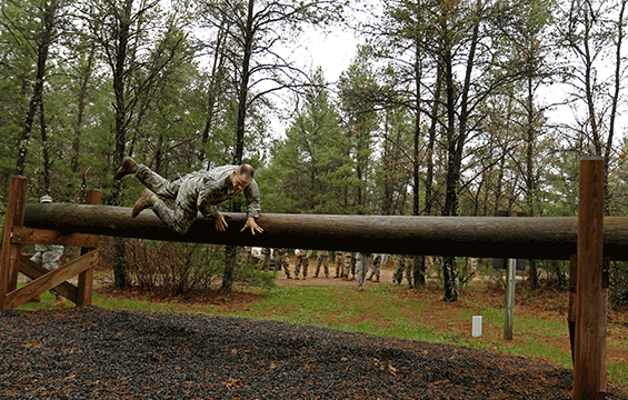Soldier going over large log "hurdle-type obstacle"  in 
