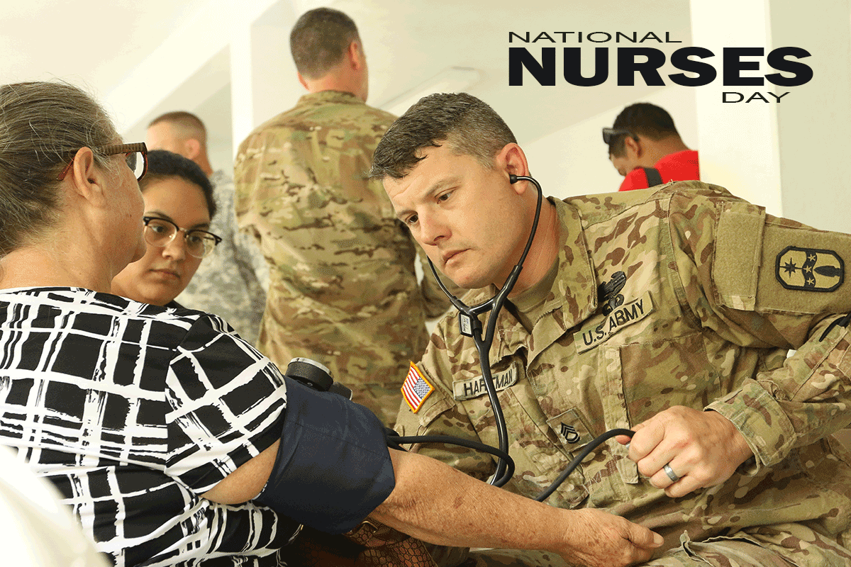 Male Soldier/Nurse takes blood pressure of female civilian.