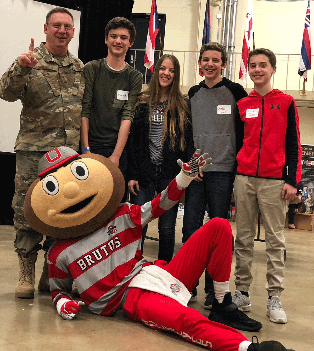 Chief Master Sgt. Thomas A. Jones stands with his children for a photo opt with Ohio State University mascot, Brutus Buckeye.