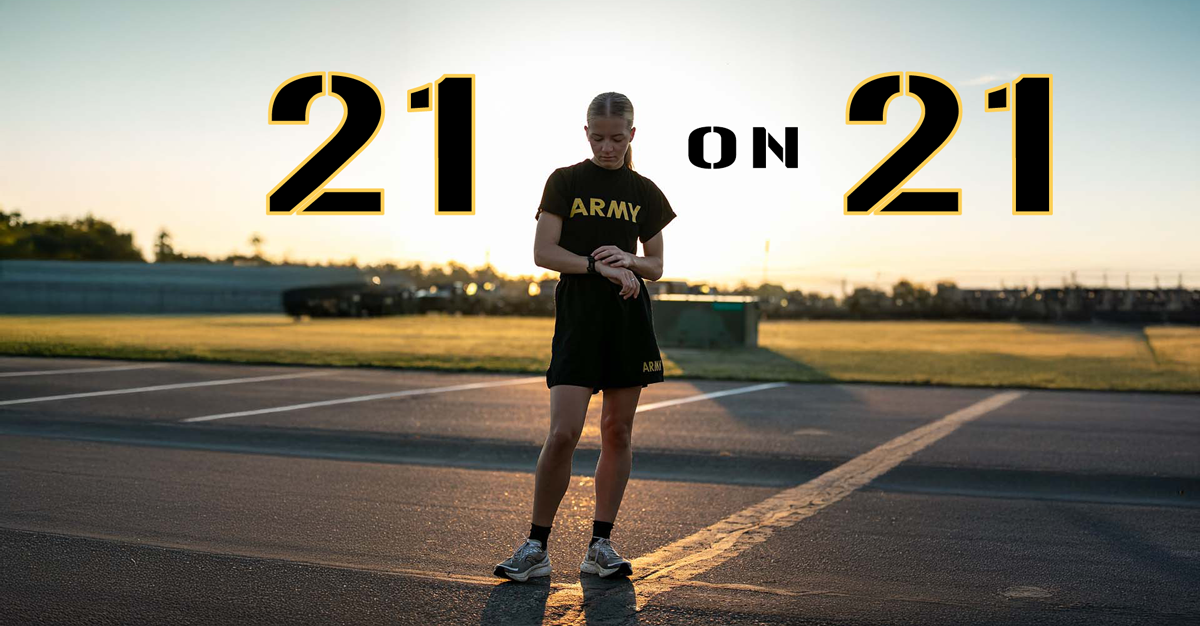 Female Soldier in Army shorts and t-shirt checking watch in parking lot