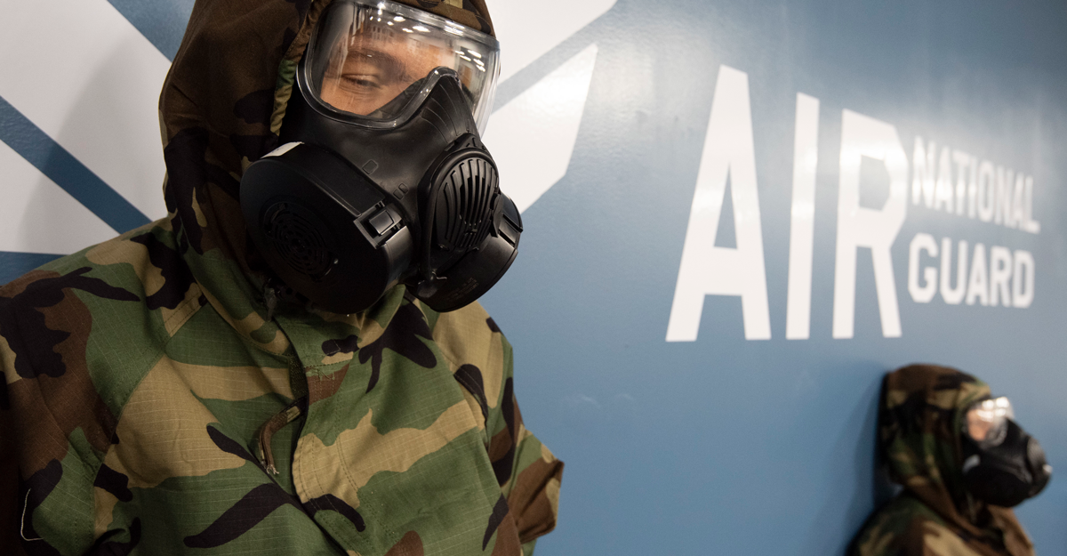 U.S. Air Force Staff Sgt. Wendy Kuhn, left, with the 121st Air Refueling Wing Public Affairs Office, awaits the 'All Clear' while wearing an M50 gas mask during a Nuclear Operational Readiness Exercise, September 20, 2021, at Rickenbacker Air National Guard Base, Ohio. The NORE is to prepare Airmen for an upcoming Nuclear Operational Readiness Inspection (NORI).
