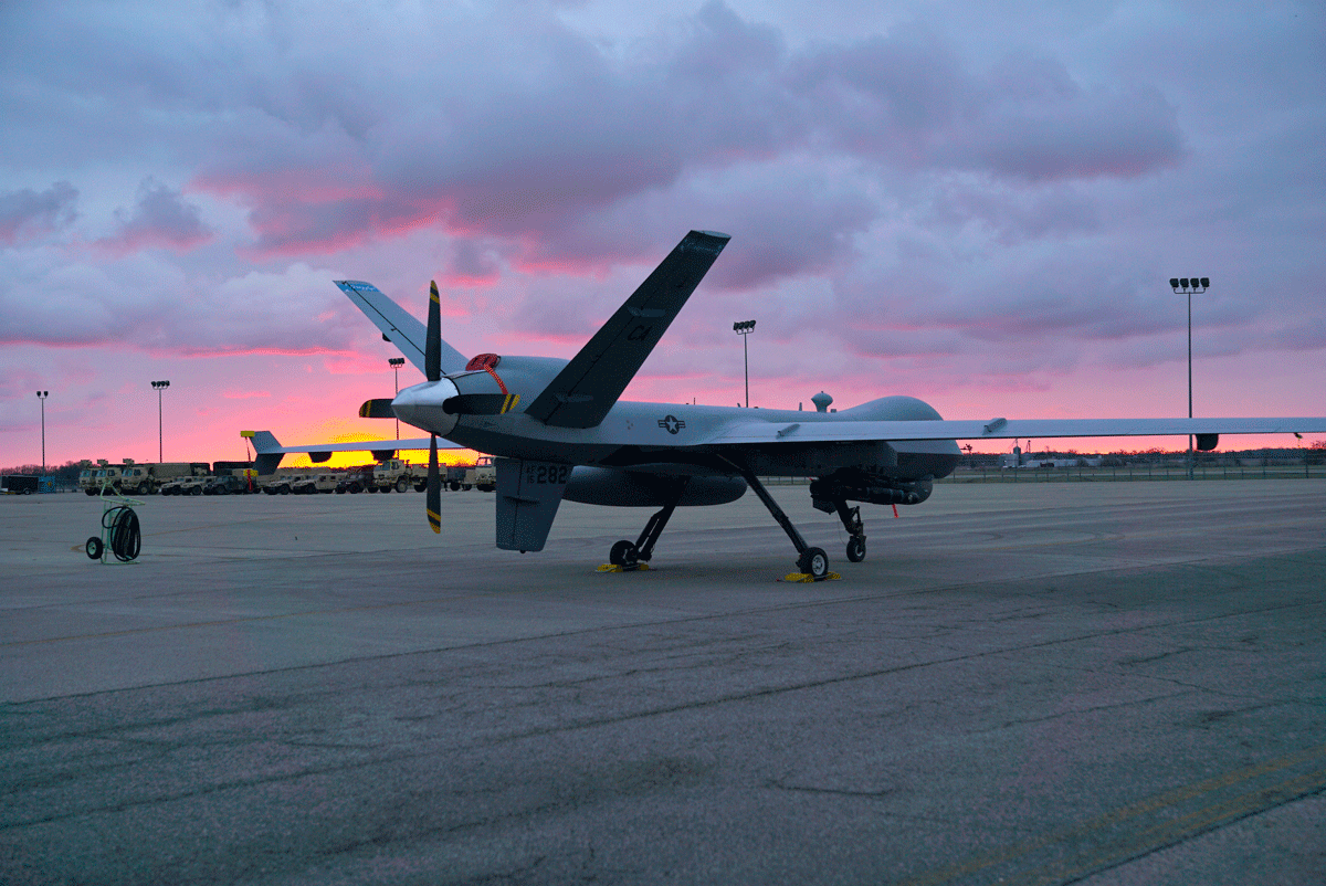 A remotely piloted MQ-9 Reaper sits in front of the 178th Wing hanger during sunrise.